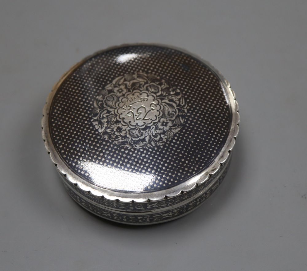 A 20th century Persian white metal and niello circular box and cover, 8cm, gross 3oz.